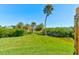 Private backyard with lush lawn and waterfront access at 114 Cedar Dunes Dr, New Smyrna Beach, FL 32169