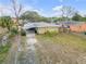Aerial view of a single-Gathering home with a carport and fenced yard at 130 Indian Creek Rd, Oak Hill, FL 32759