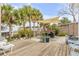 Spacious backyard deck with patio furniture, shade sail, and tropical landscaping at 130 Indian Creek Rd, Oak Hill, FL 32759