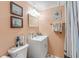 Clean bathroom with white vanity, mirror, and striped shower curtain at 130 Indian Creek Rd, Oak Hill, FL 32759