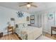 Charming bedroom with light blue walls, ceiling fan, and unique crab decor at 130 Indian Creek Rd, Oak Hill, FL 32759