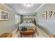 Bedroom with light green walls, wooden furniture, and coastal decor at 130 Indian Creek Rd, Oak Hill, FL 32759