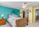Inviting bedroom with teal accent wall, wooden furniture, and ceiling fan at 130 Indian Creek Rd, Oak Hill, FL 32759