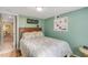Cozy bedroom with green walls, wooden furniture, and coastal-themed bedding at 130 Indian Creek Rd, Oak Hill, FL 32759