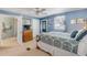Bedroom with wooden bed, ceiling fan, and ensuite bathroom access at 130 Indian Creek Rd, Oak Hill, FL 32759