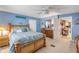 Inviting bedroom with wooden furniture, ceiling fan, and view into another room at 130 Indian Creek Rd, Oak Hill, FL 32759