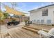 Large wooden deck with outdoor dining area, seating, and lush greenery at 130 Indian Creek Rd, Oak Hill, FL 32759