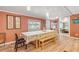 Dining area with a table, chairs, and a view into an adjacent bedroom at 130 Indian Creek Rd, Oak Hill, FL 32759