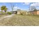 Front view of the house with a carport and a fenced yard at 130 Indian Creek Rd, Oak Hill, FL 32759