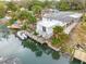 Waterfront home with dock, boat lift, and lush landscaping at 130 Indian Creek Rd, Oak Hill, FL 32759