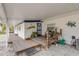 Wooden front porch with nautical decor, seating, and a welcome mat at 130 Indian Creek Rd, Oak Hill, FL 32759