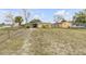One-story home exterior with fenced yard, driveway, and landscaping at 130 Indian Creek Rd, Oak Hill, FL 32759