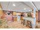 Kitchen with ample counter space, wood cabinetry, white appliances, and bar seating at 130 Indian Creek Rd, Oak Hill, FL 32759