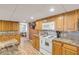 Functional kitchen equipped with a microwave, electric stove, and wooden cabinetry at 130 Indian Creek Rd, Oak Hill, FL 32759