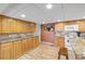 Spacious kitchen featuring wooden cabinetry, white appliances, and ample counter space at 130 Indian Creek Rd, Oak Hill, FL 32759