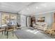 Living room with white couch, dining area, and outdoor access at 130 Indian Creek Rd, Oak Hill, FL 32759