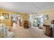 Inviting living room with views into the adjacent kitchen and a small sitting room at 130 Indian Creek Rd, Oak Hill, FL 32759