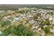 Aerial view of the neighborhood with waterfront homes and lush trees at 130 Indian Creek Rd, Oak Hill, FL 32759