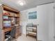 Cozy office area with desk, chair, shelving, nautical accents, and plenty of natural light at 130 Indian Creek Rd, Oak Hill, FL 32759