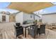 Outdoor dining area on a wooden deck with a shade sail at 130 Indian Creek Rd, Oak Hill, FL 32759