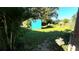 Large backyard with grassy area, shed, and stone pathway at 131 W Palm Way, Edgewater, FL 32132