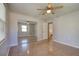 Bedroom with mirrored closet doors, ceiling fan and terrazzo flooring at 132 Ellison Ave, New Smyrna Beach, FL 32168