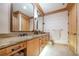 Double vanity bathroom with granite countertops and wood cabinets at 1653 N Us Highway 1 # 201, Ormond Beach, FL 32174
