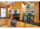 Kitchen with wood cabinets, a microwave, and a cooktop at 1653 N Us Highway 1 # 201, Ormond Beach, FL 32174
