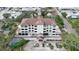 Aerial view of the condo building showing the pool and parking at 200 S Riverside Dr # 2010, New Smyrna Beach, FL 32168