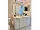 Bathroom boasts a vanity with storage and an updated light fixture at 200 S Riverside Dr # 2010, New Smyrna Beach, FL 32168