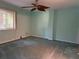 Spacious bedroom with ceiling fan and window at 200 S Riverside Dr # 2010, New Smyrna Beach, FL 32168