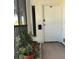Building entrance with potted plants and a white door at 200 S Riverside Dr # 2010, New Smyrna Beach, FL 32168