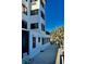 Condo building exterior with a walkway and tropical landscaping at 200 S Riverside Dr # 2010, New Smyrna Beach, FL 32168