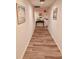 Building hallway with wood-look floors and wall art at 200 S Riverside Dr # 2010, New Smyrna Beach, FL 32168
