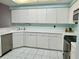 Galley kitchen with white cabinets and stainless steel appliances at 200 S Riverside Dr # 2010, New Smyrna Beach, FL 32168