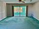 Spacious living room with sliding glass doors leading to a patio at 200 S Riverside Dr # 2010, New Smyrna Beach, FL 32168