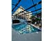 Community pool with a screened enclosure and lounge chairs at 200 S Riverside Dr # 2010, New Smyrna Beach, FL 32168