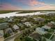 Wide aerial view of waterfront property with a home and surrounding neighborhood at 2022 N Peninsula Ave, New Smyrna Beach, FL 32169