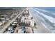 Aerial view of beachfront property, showing ocean, beach, and buildings at 2401 S Atlantic Ave # C206, New Smyrna Beach, FL 32169
