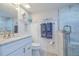 White bathroom featuring marble countertop and spacious walk-in shower at 2401 S Atlantic Ave # C206, New Smyrna Beach, FL 32169