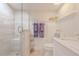 Bright bathroom with white cabinetry, marble countertop, and a walk-in shower at 2401 S Atlantic Ave # C206, New Smyrna Beach, FL 32169