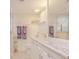Clean bathroom with white vanity, marble countertop, and a walk-in shower at 2401 S Atlantic Ave # C206, New Smyrna Beach, FL 32169