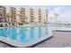 Community pool with lounge chairs, perfect for relaxation at 2401 S Atlantic Ave # C206, New Smyrna Beach, FL 32169