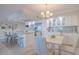 Open concept kitchen and dining area with white cabinetry and sleek appliances at 2401 S Atlantic Ave # C206, New Smyrna Beach, FL 32169