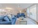 Open concept living room and kitchen with blue couches and coastal decor at 2401 S Atlantic Ave # C206, New Smyrna Beach, FL 32169