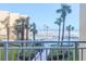 Community pool with palm trees, lounge chairs, and direct beach access at 2401 S Atlantic Ave # C206, New Smyrna Beach, FL 32169