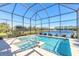 Refreshing pool and spa with screened enclosure, offering lake views at 265 Venetian Palms Blvd, New Smyrna Beach, FL 32168