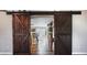 Home entry featuring rustic barn doors opening to a view of the kitchen and living areas at 2729 Pine Tree Dr, Edgewater, FL 32141