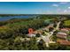 Aerial view of home on a tree-lined street, near water at 2853 Turnbull Estates Dr, New Smyrna Beach, FL 32168