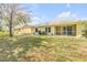 Large backyard with grassy area and screened patio at 2853 Turnbull Estates Dr, New Smyrna Beach, FL 32168